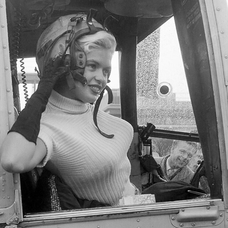 Jayne Mansfield wearing a helmet in a vehile